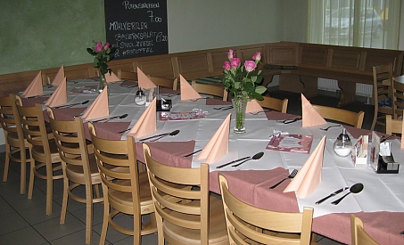Festlich gedeckte Tafel mit Blumen und gefalteten Servietten